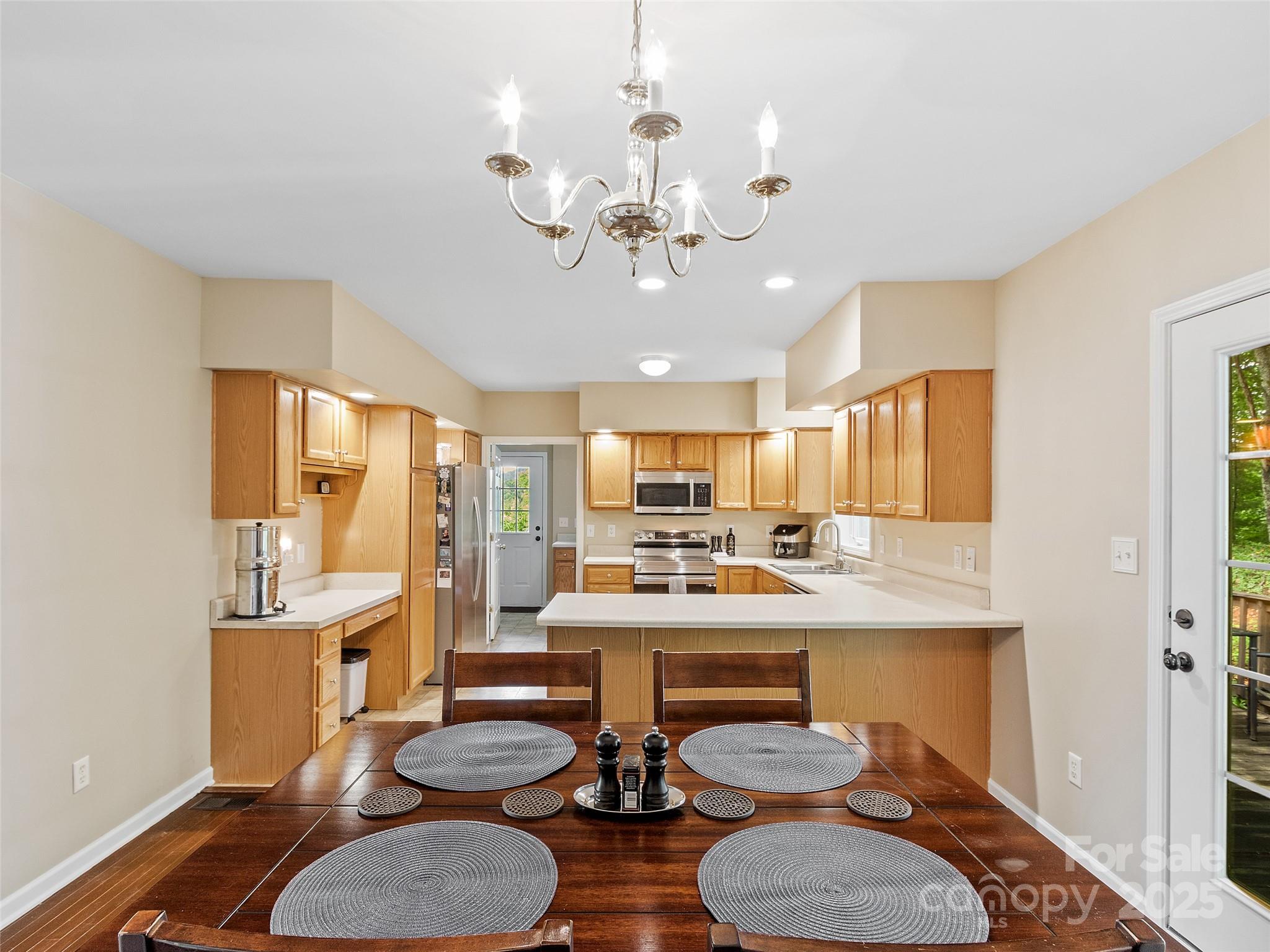161 Blue Rock Road Burnsville, NC 28714 - Photo 9 of 48 a room with stainless steel appliances kitchen island granite countertop furniture and a kitchen view