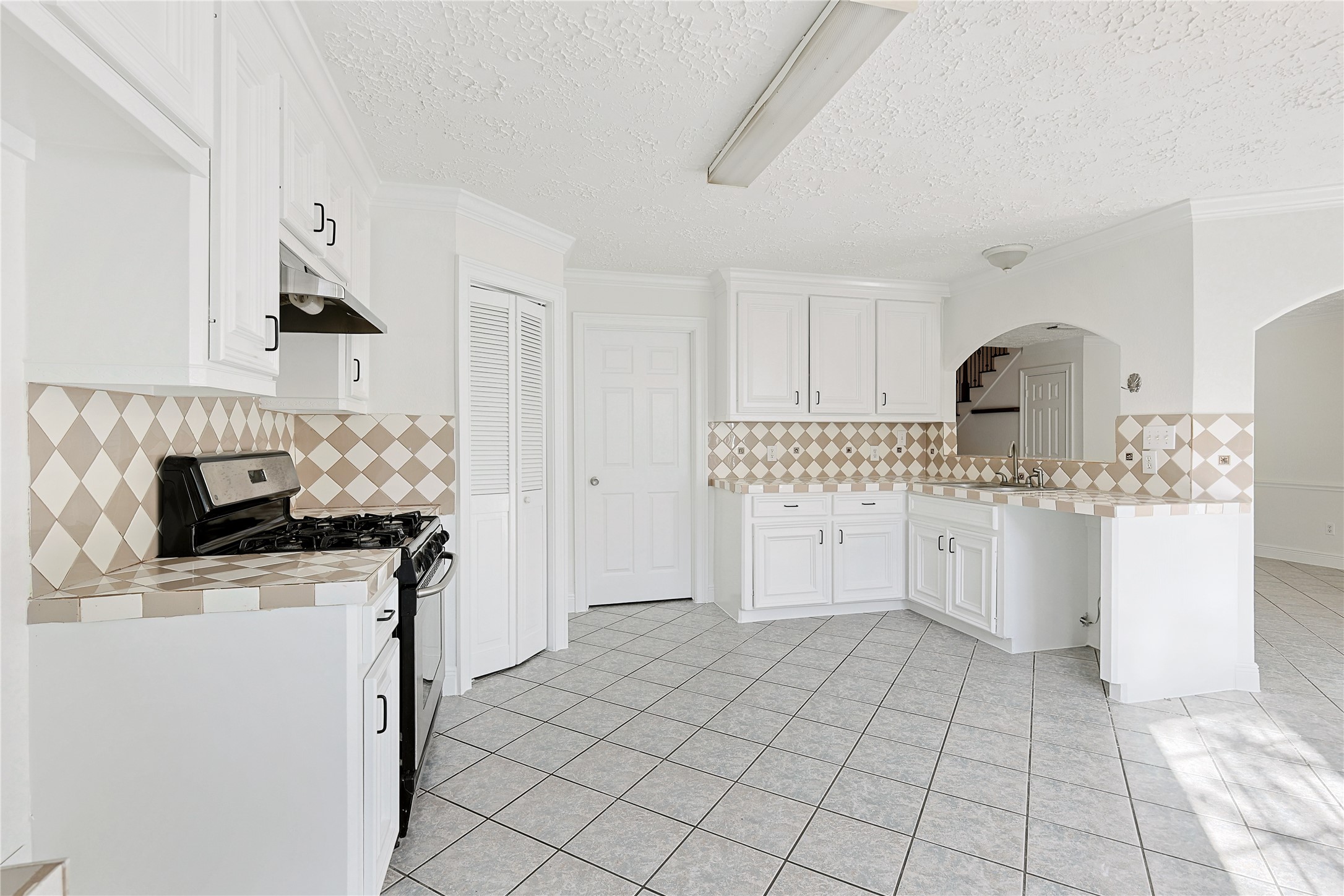 8502 Detroit Street, Unit C Houston, TX 77017 - Photo 7 of 15 a kitchen with white cabinets and appliances