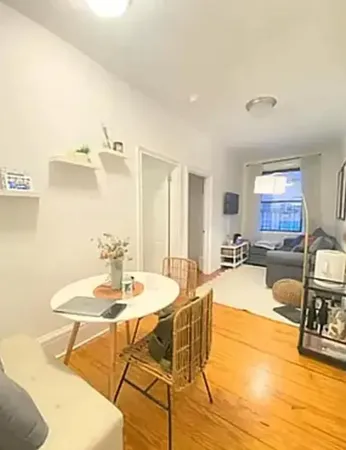 a dining room with furniture and wooden floor