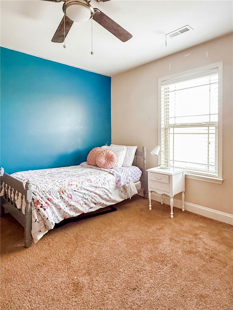 2409 Watkins Road Anderson, SC 29625 - Photo 31 of 44 This cozy bedroom features a ceiling fan, plush carpet, and ample natural light.