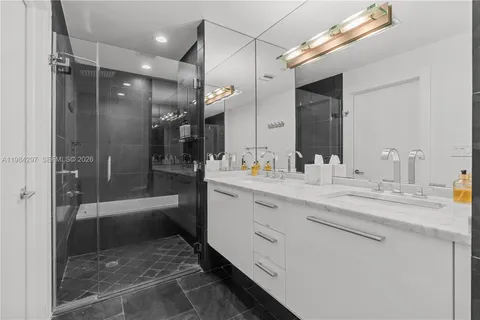 a bathroom with a sink mirror and toilet