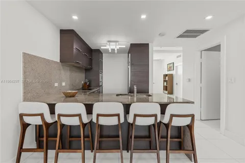 a kitchen with stainless steel appliances granite countertop a stove and a refrigerator