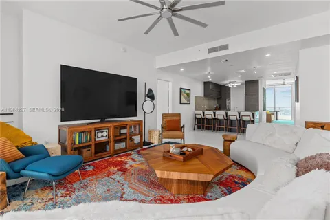 a bedroom with a bed a chandelier and a window