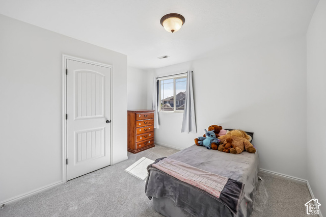 3863 East Cascade Road, Unit 3 Eagle Mountain, UT 84005 - Photo 19 of 37 Soft gray carpeting, white walls, and a window with natural light