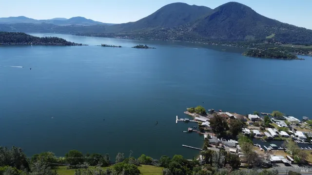an aerial view of residential house with outdoor space and trees all around