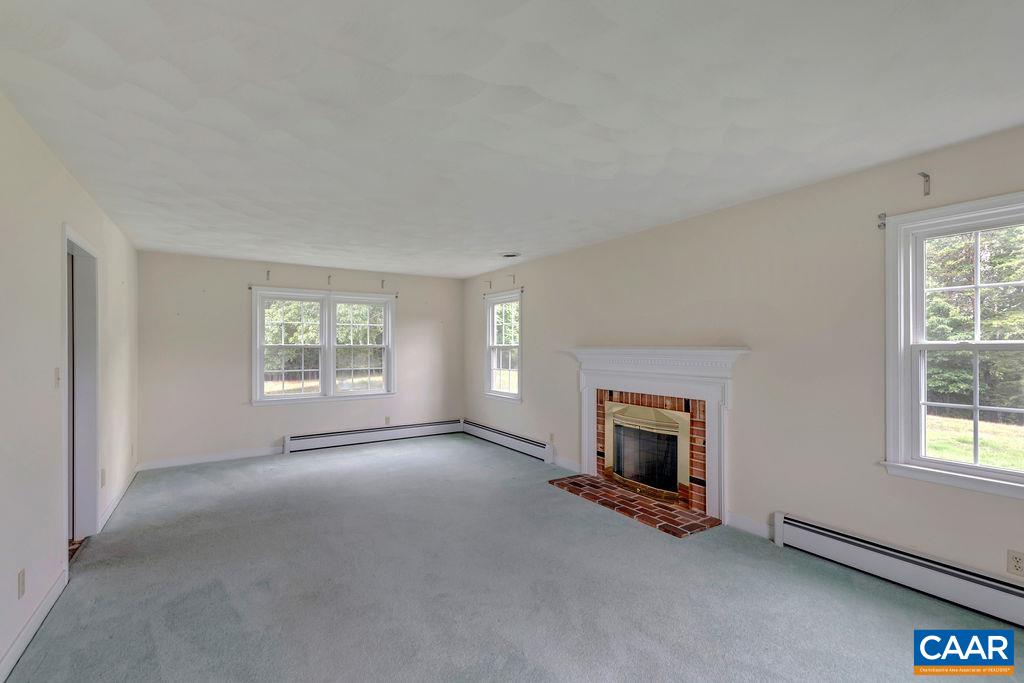 3350 Ridge Road Charlottesville, VA 22901 - Photo 4 of 45 an empty room with fireplace and windows