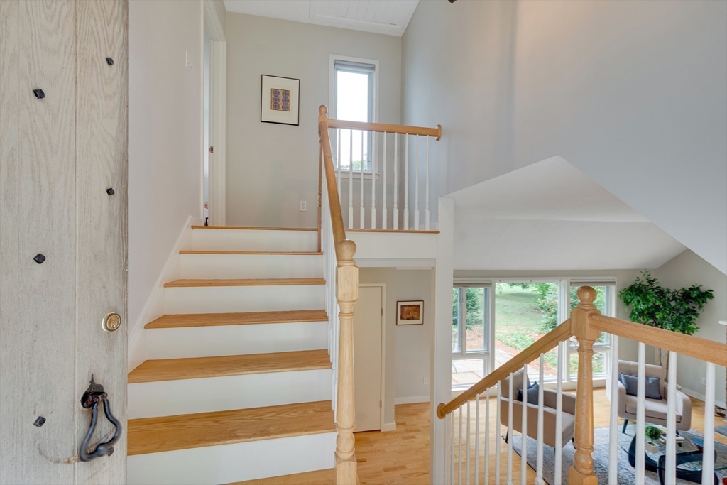 41 Todd Pond Road, Unit 41 Lincoln, MA 01773 - Photo 18 of 26 a view of staircase with lots of frames on wall and a window