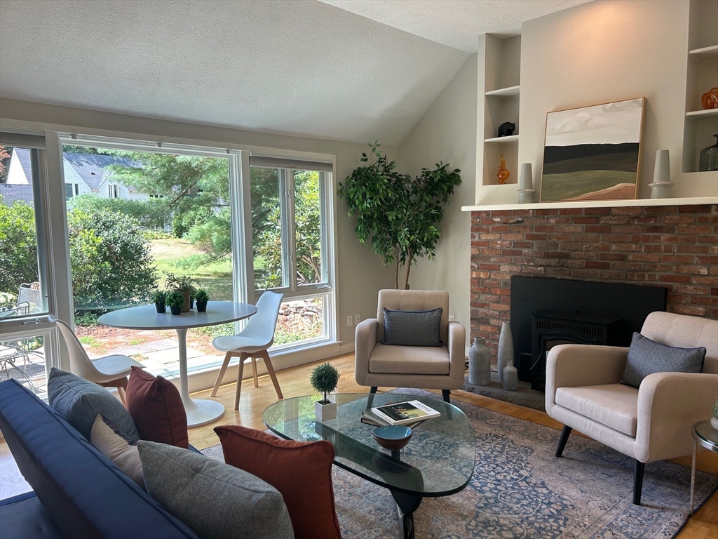 41 Todd Pond Road, Unit 41 Lincoln, MA 01773 - Photo 9 of 26 a living room with furniture fireplace and a large window