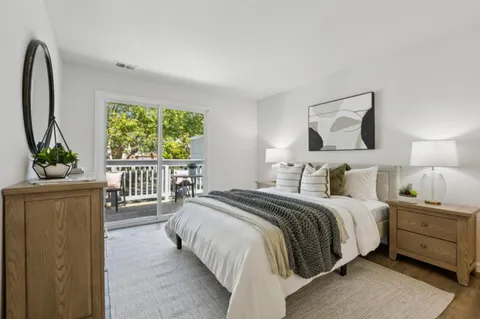 a bedroom with a bed and a large window