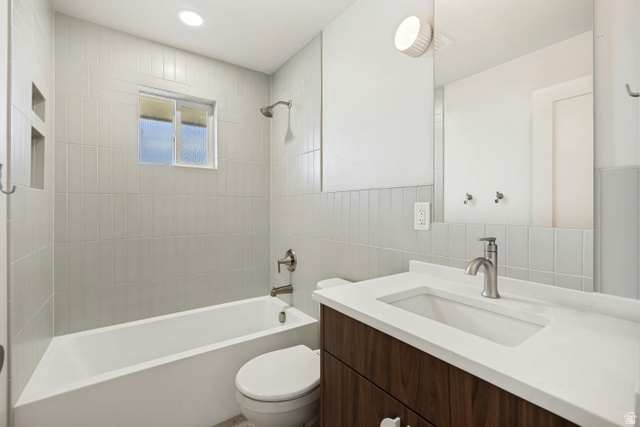 1168 East Center Street Bountiful, UT 84010 - Photo 23 of 38 Bathroom featuring a wood-finish vanity with an integrated white sink, brushed nickel faucet, and a large wall-mounted mirror