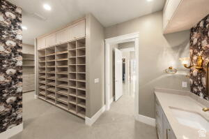 1141 East Lost Ridge Drive Washington, UT 84780 - Photo 73 of 108 Custom walk-in closet featuring extensive built-in shelving, overhead cabinetry, and recessed lighting
