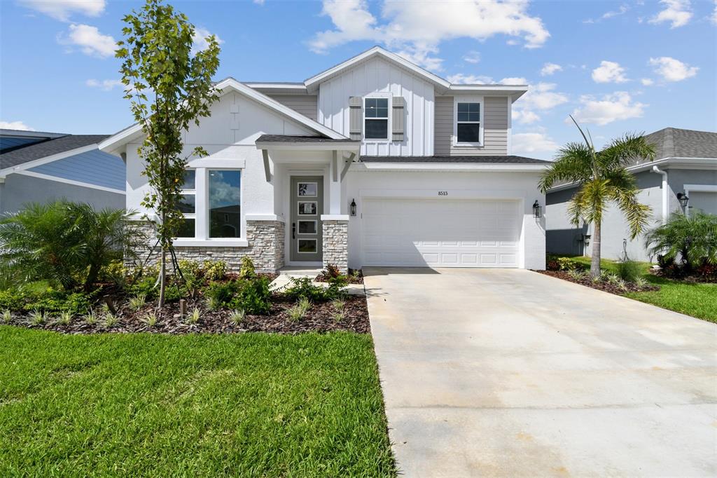 8515 Wappinger Place Parrish, FL 34219 - Photo 1 of 1 a front view of a house with a garden and plants