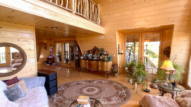 2498 West Silverado Ridge Alton, UT 84710 - Photo 13 of 51 Living area with french doors, wood walls, wood finished floors, and a high wooden ceiling