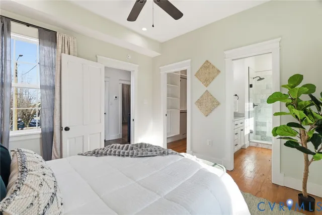 a bedroom with a bed and a potted plant