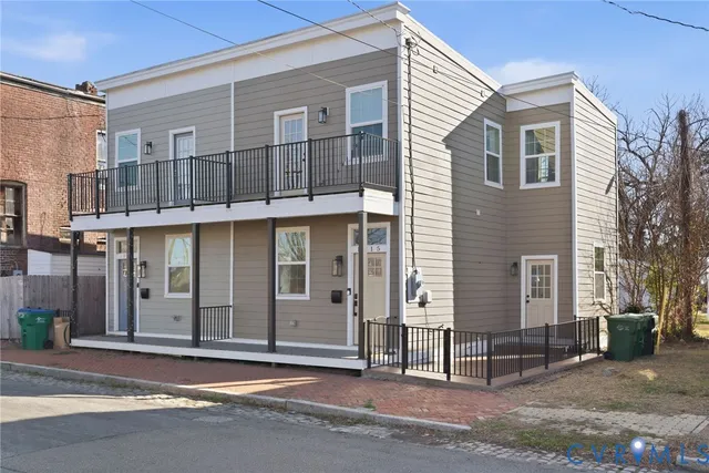 a view of a house with a garage and balcony