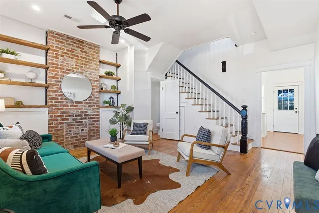 a living room with furniture and a wooden floor