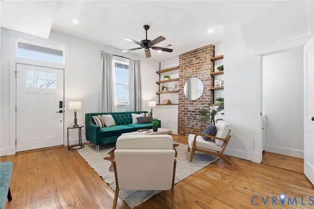 a living room with fireplace furniture and a wooden floor