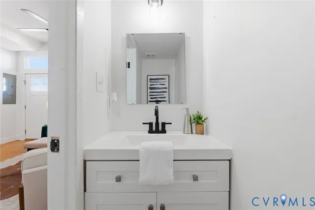 a bathroom with a sink vanity and a mirror