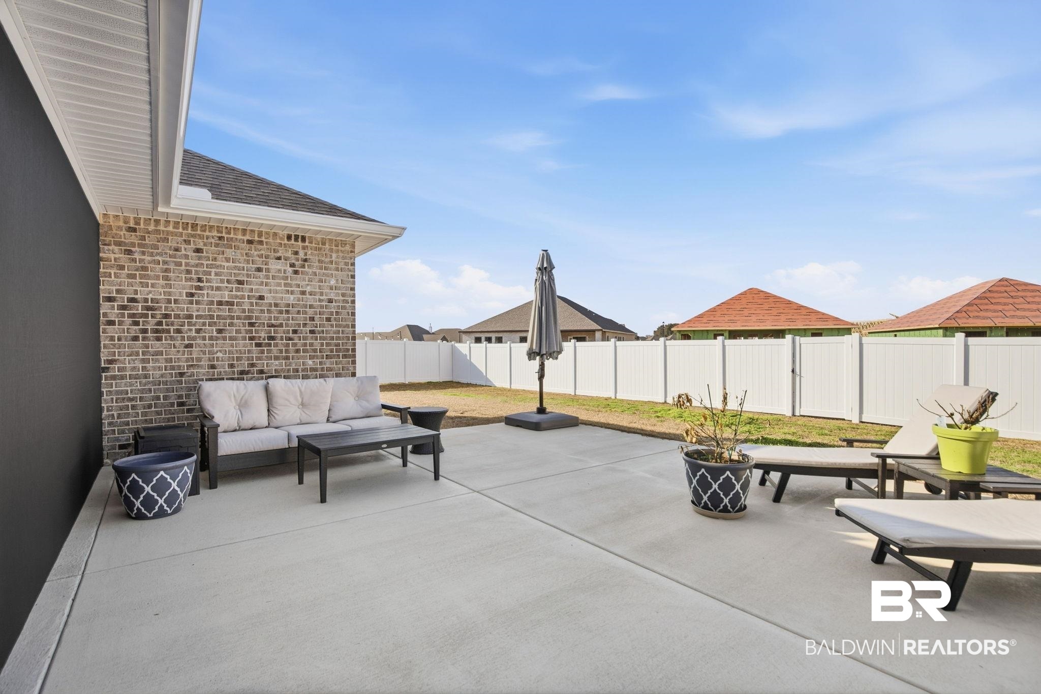 11123 Genuine Risk Circle Daphne, AL 36526 - Photo 53 of 67 Fenced backyard featuring a patio area and outdoor seating