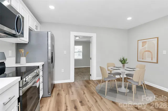 a view of a kitchen with furniture and wooden floor