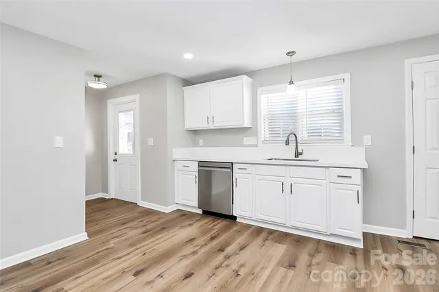 a kitchen with granite countertop white cabinets and white appliances