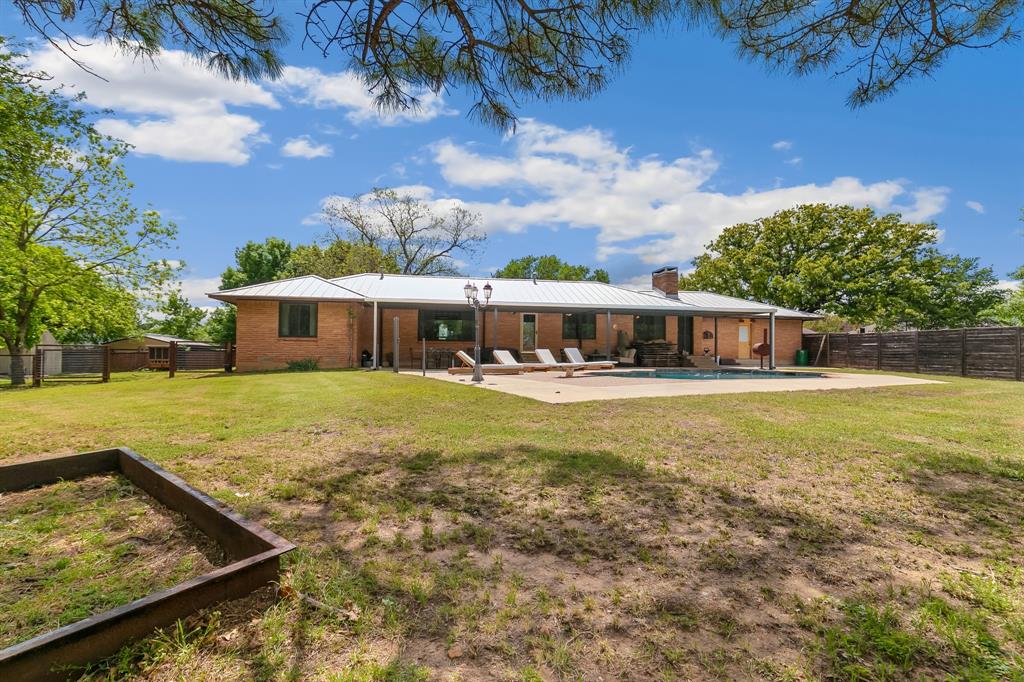 3615 Fritz Lane Corinth, TX 76208 - Photo 23 of 33 Backyard with lots of grassy room, large covered patio and an inground pool with a diving board.