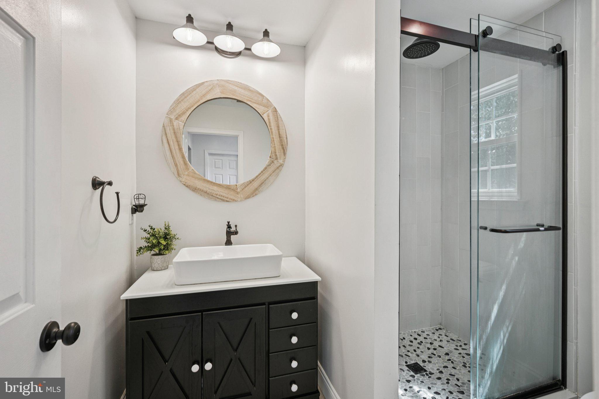 39 Willow Ridge Road Marlton, NJ 08053 - Photo 35 of 43 a bathroom with a sink a mirror and a shower curtain