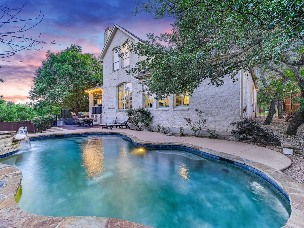 a swimming pool with outdoor seating and yard