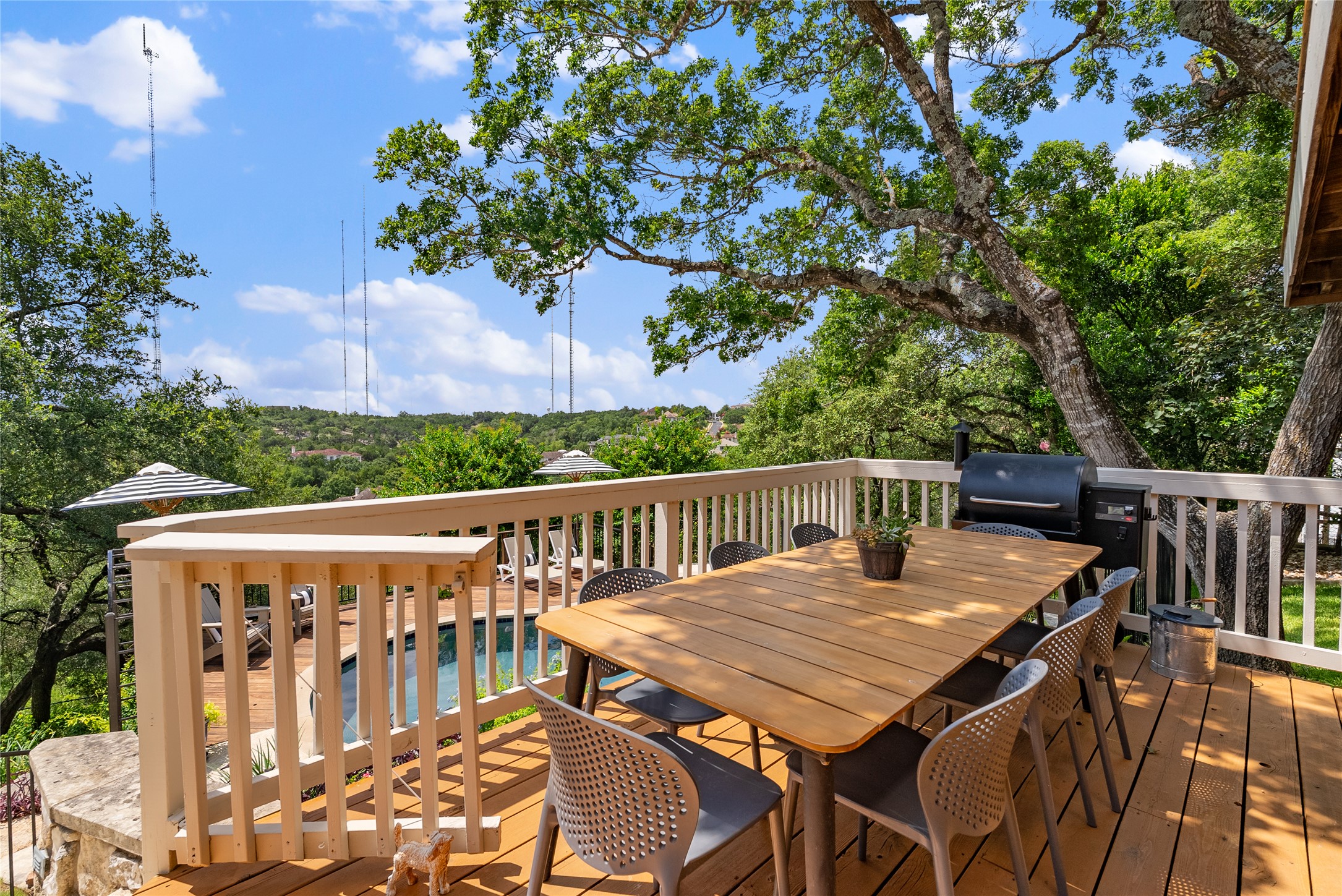 3107 Lookout Lane Austin, TX 78746 - Photo 17 of 39 An inviting deck with an outdoor dining set offers scenic views and ample space for al fresco entertaining.
