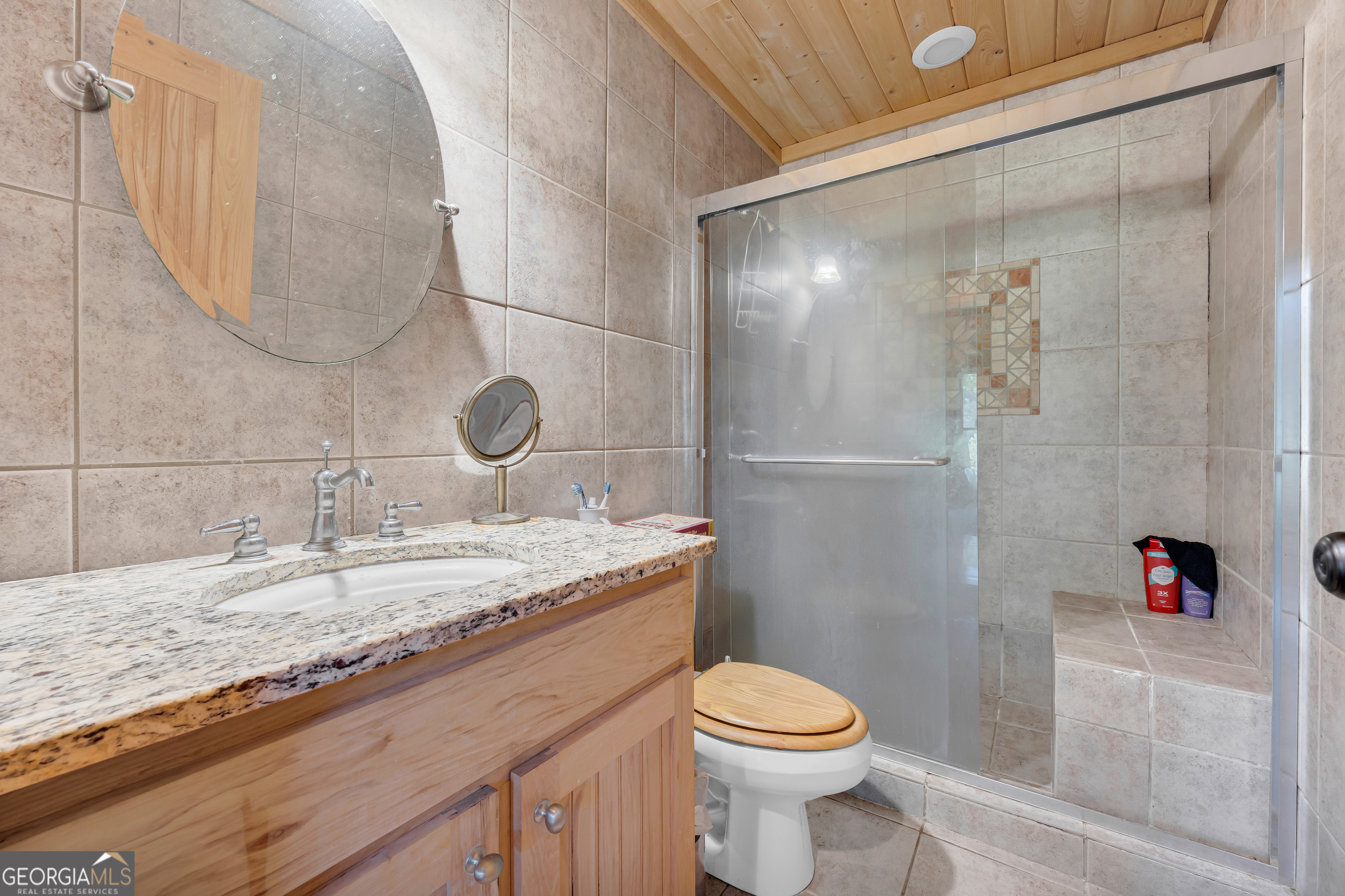1641 Churchwell Rd Union Point Union Point, GA 30669 - Photo 28 of 48 a bathroom with a granite countertop sink a toilet and shower