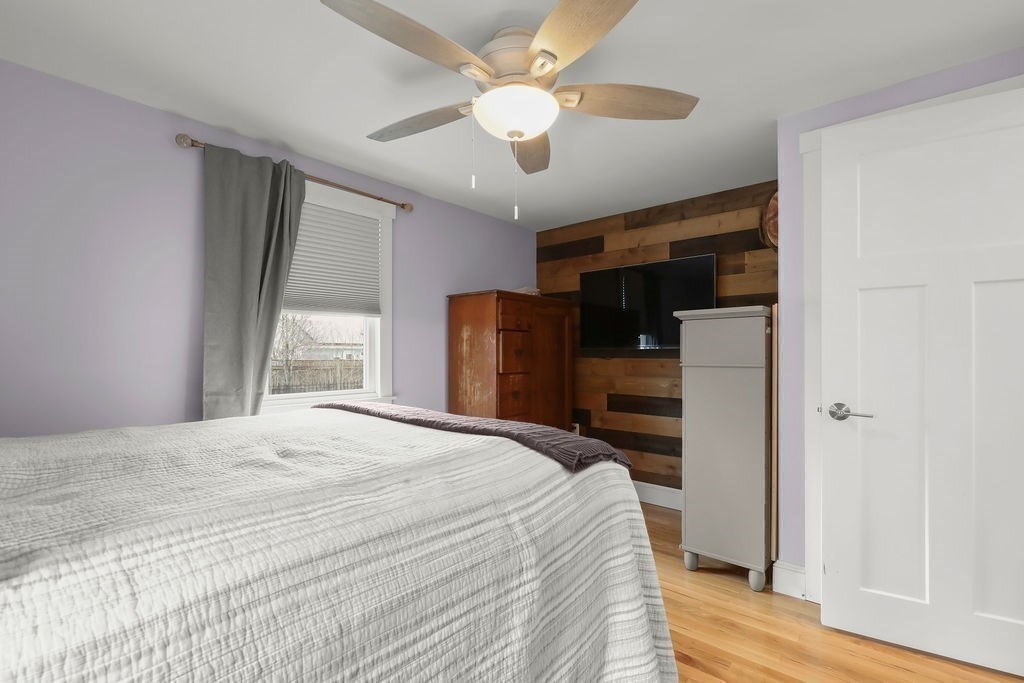 13 Monack Road Wareham, MA 02532 - Photo 18 of 28 a bedroom with a bed and a chandelier