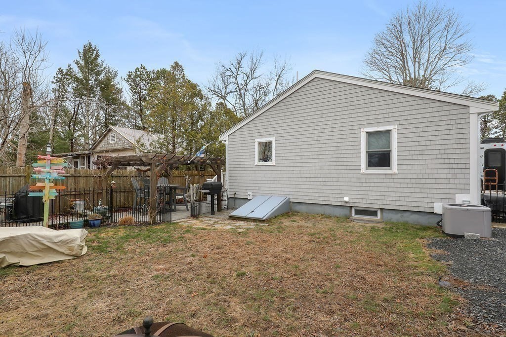 13 Monack Road Wareham, MA 02532 - Photo 24 of 28 a backyard of a house with barbeque oven and outdoor seating