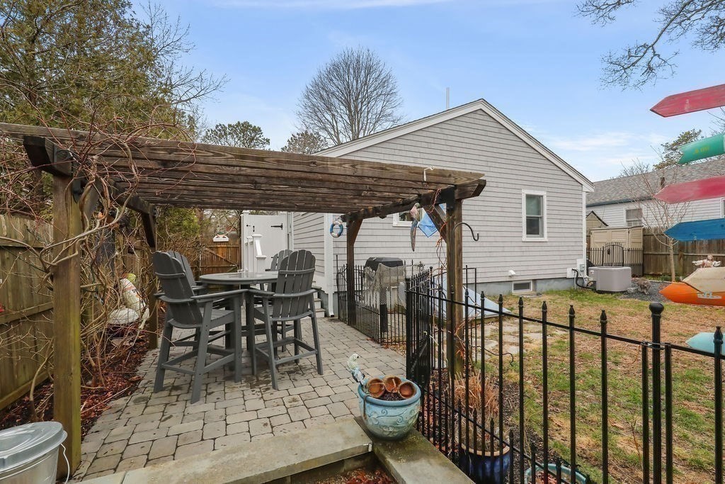 13 Monack Road Wareham, MA 02532 - Photo 25 of 28 a view of a patio with table and chairs and potted plants