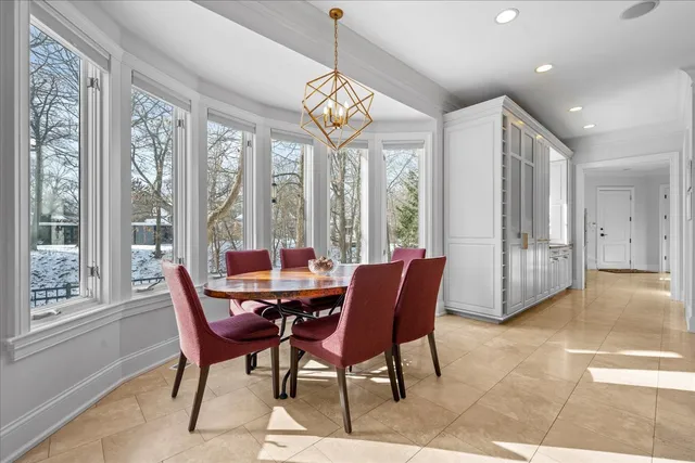 a view of a dining room with furniture a chandelier and wooden floor