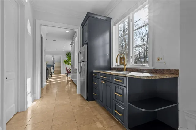 a kitchen with stainless steel appliances granite countertop a sink and a stove