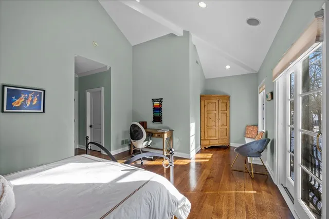 a room with two beds and a chair