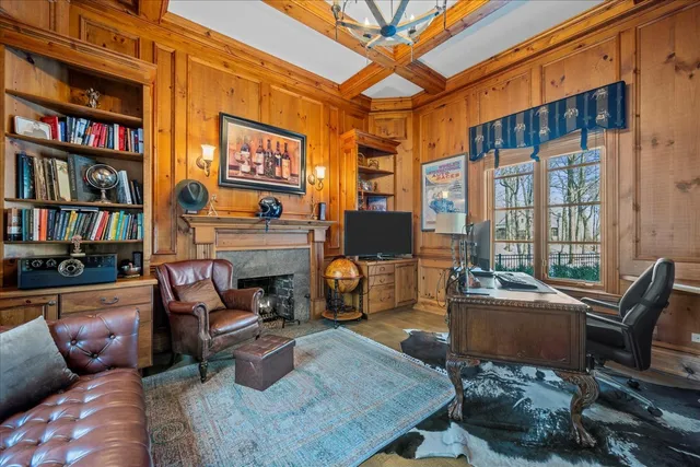 a living room with furniture fireplace and book shelf