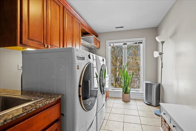 a utility room with multiple dryer and washer