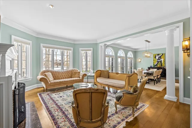 a living room with furniture and a floor to ceiling window