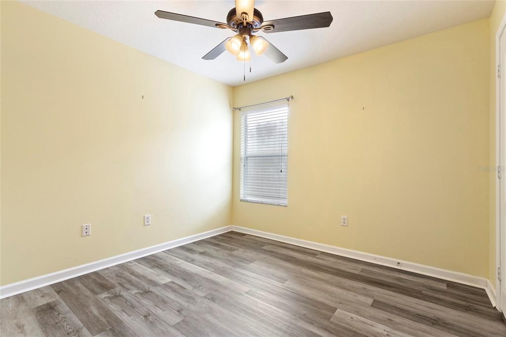 8324 72nd Lane East Bradenton, FL 34201 - Photo 11 of 50 an empty room with a window and a ceiling fan