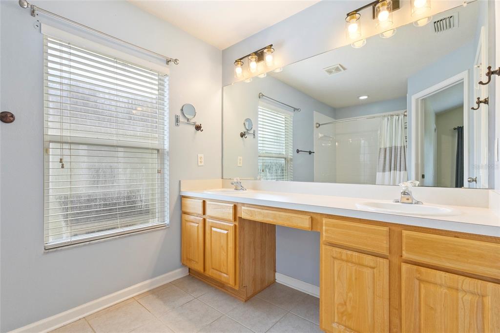 8324 72nd Lane East Bradenton, FL 34201 - Photo 13 of 50 a spacious bathroom with a sink mirror and a bathtub