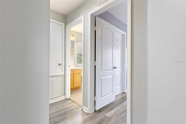 a view of a hallway with wooden floor
