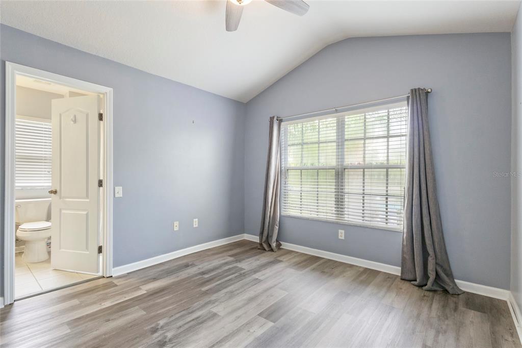 8324 72nd Lane East Bradenton, FL 34201 - Photo 20 of 50 an empty room with wooden floor and windows