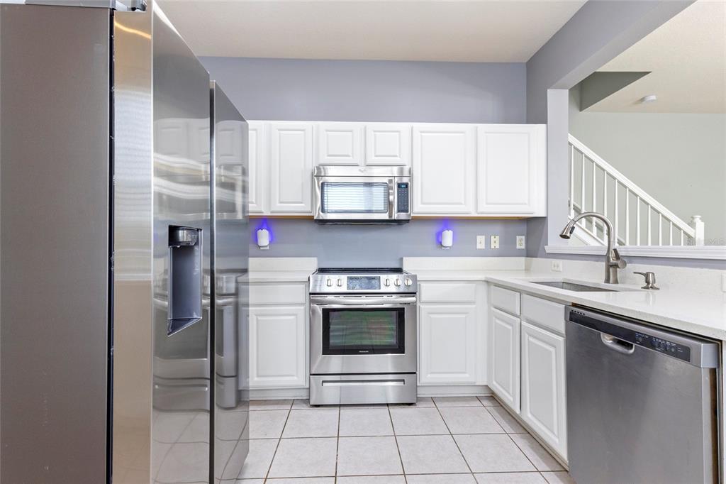 8324 72nd Lane East Bradenton, FL 34201 - Photo 2 of 50 a kitchen with stainless steel appliances granite countertop a sink and a refrigerator