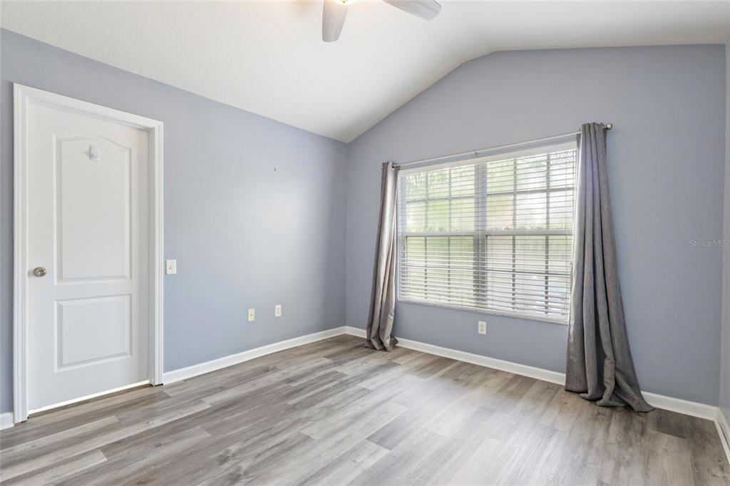8324 72nd Lane East Bradenton, FL 34201 - Photo 21 of 50 an empty room with wooden floor and windows