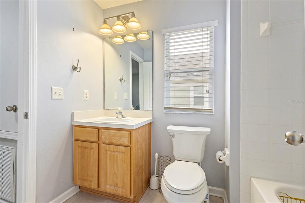 8324 72nd Lane East Bradenton, FL 34201 - Photo 22 of 50 a bathroom with a toilet a sink and a mirror
