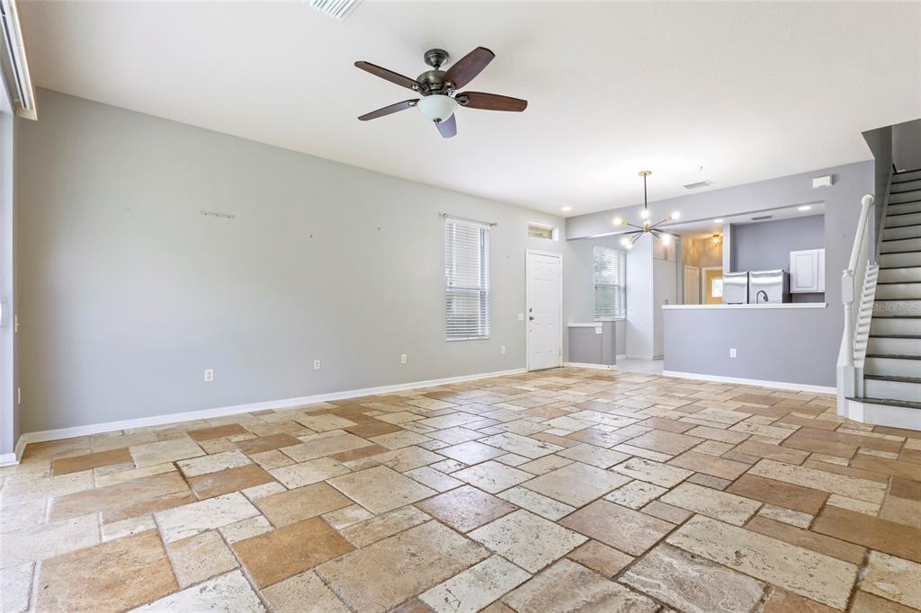 8324 72nd Lane East Bradenton, FL 34201 - Photo 28 of 50 a view of a livingroom with a chandelier fan and a kitchen