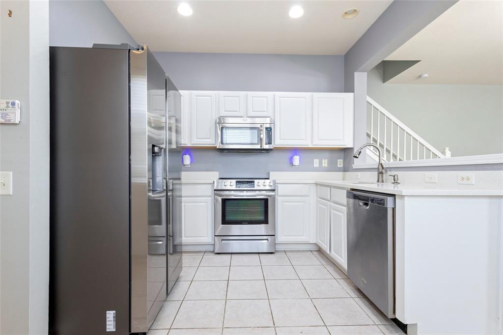 8324 72nd Lane East Bradenton, FL 34201 - Photo 29 of 50 a kitchen with a refrigerator sink and cabinets