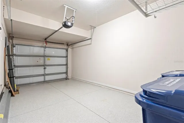 an empty room with wooden floor and a ceiling fan