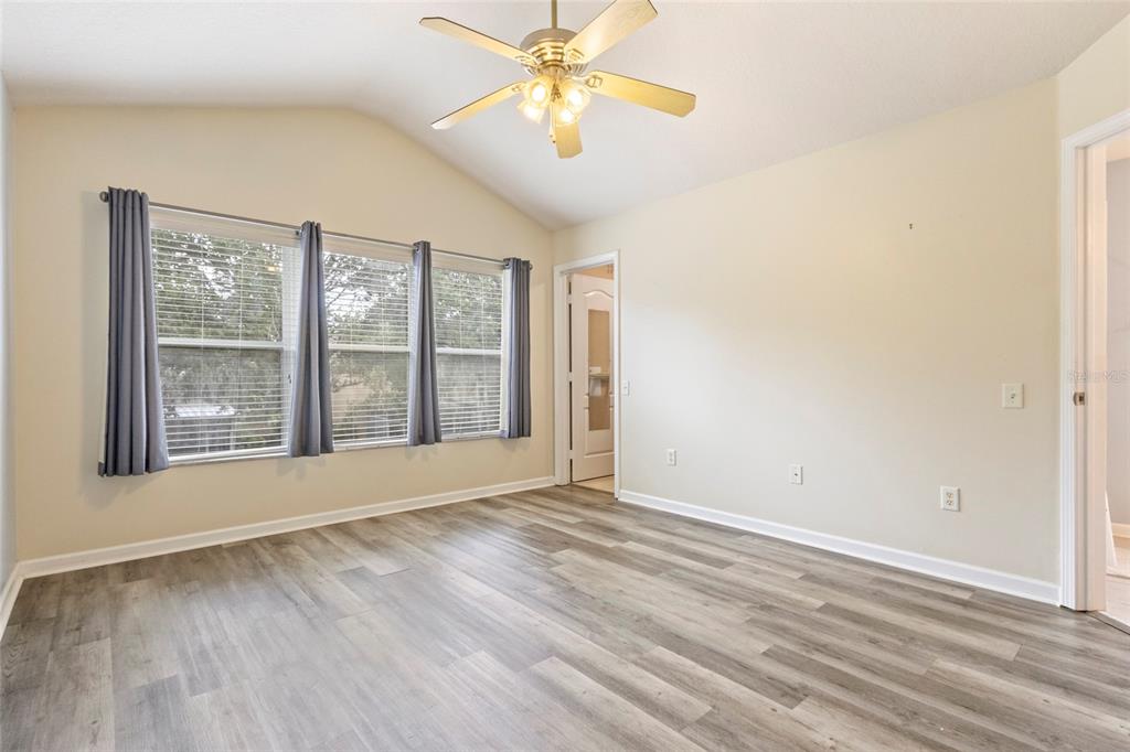 8324 72nd Lane East Bradenton, FL 34201 - Photo 32 of 50 a view of an empty room with window and chandelier fan